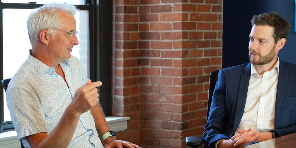 Charlie Paterson in discussion with a colleague