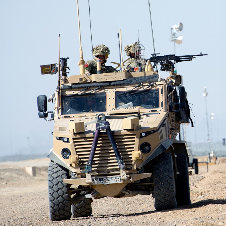 Military vehicle with soldiers driving