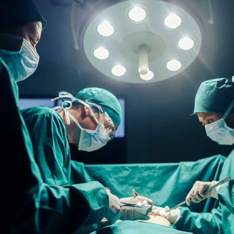 Surgeons performing surgery in an operating room