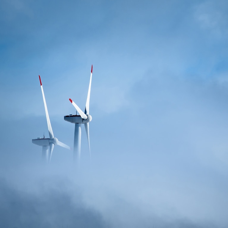 Low angle view of windmill against cloudy sky