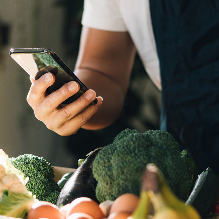 Man ordering fresh food delivery with mobile phone