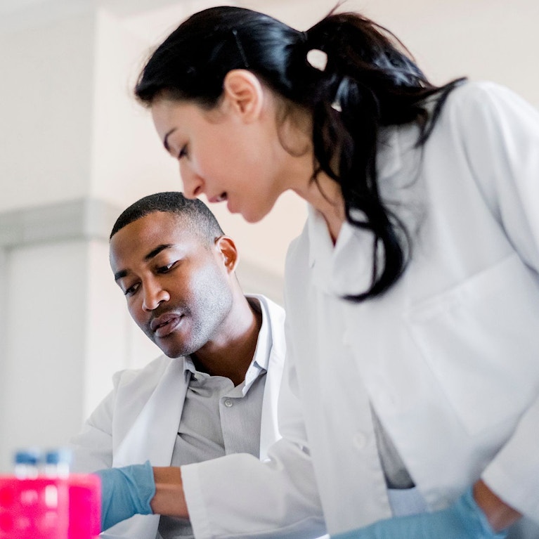 Two clinicians in research lab