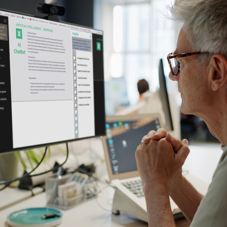 Man looking at a computer screen in an office.