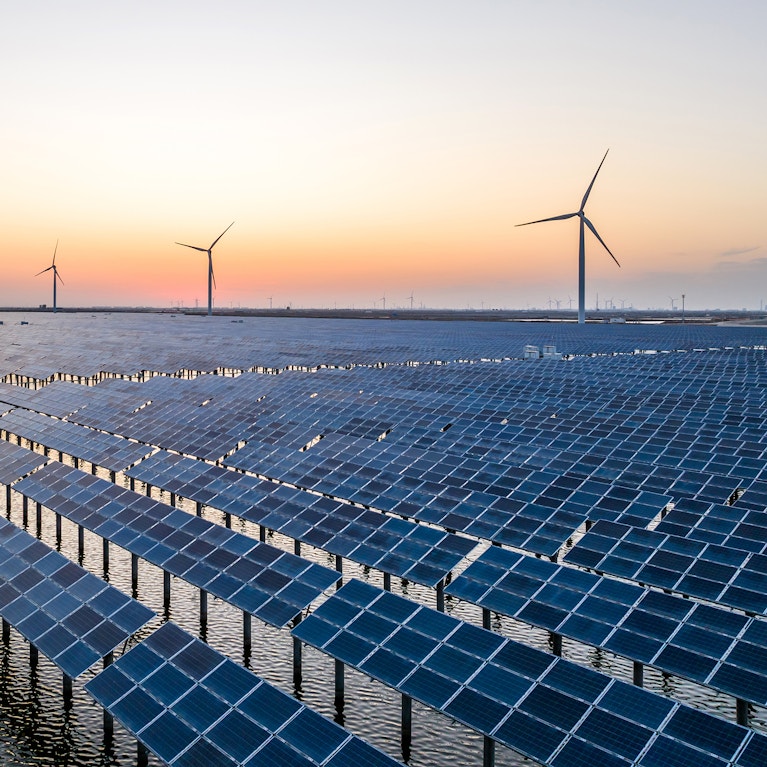 Solar panels and wind power at dusk