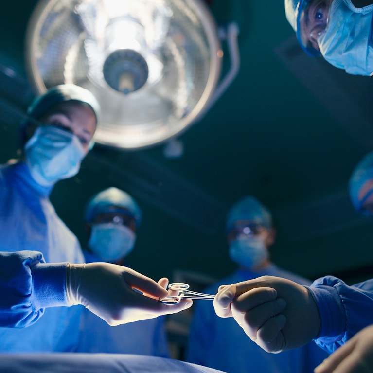 Operating room staff performing hospital surgery