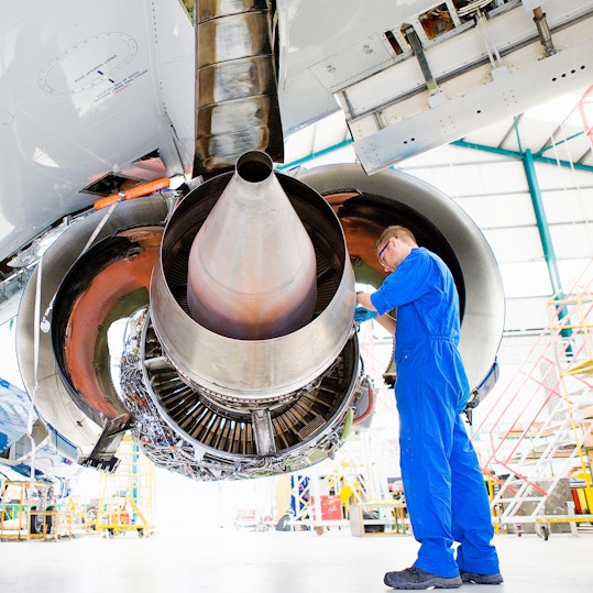 Person repairing aircraft engine