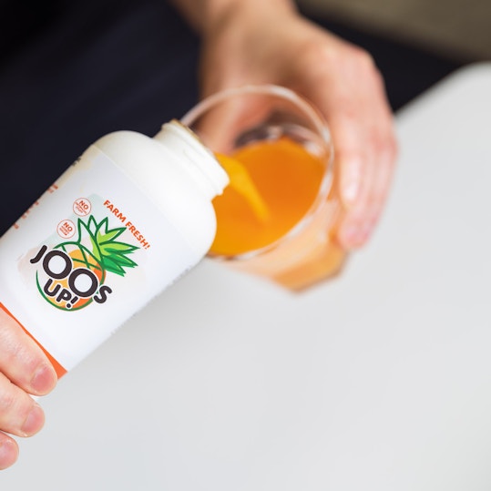 Pouring juice from sustainable bottle