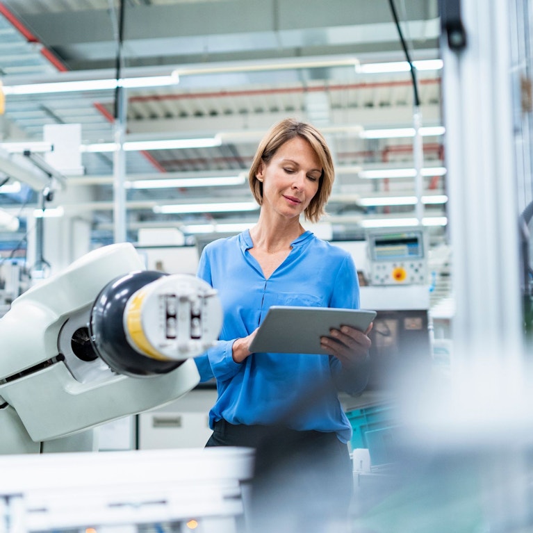 Woman controlling machinery in a factory