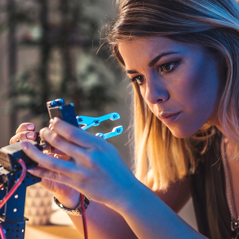 Woman building a product using mechanical machine