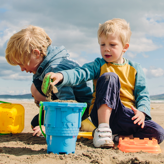 Boys making sandcastles on the beach