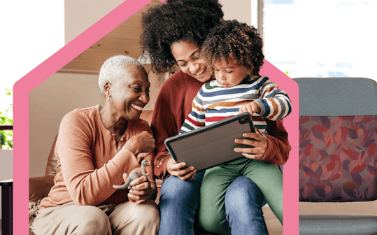 Family together looking at tablet device