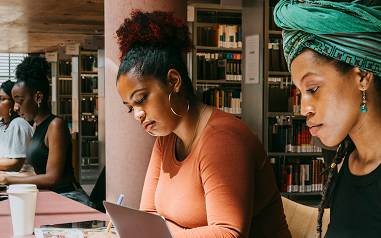 Two women sitting together working