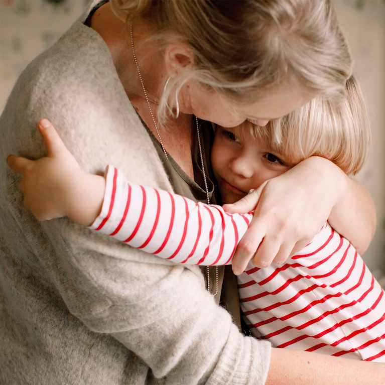 Mother hugging her daughter.