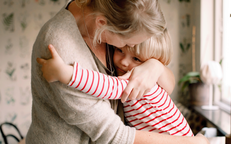 Mother hugging her daughter.