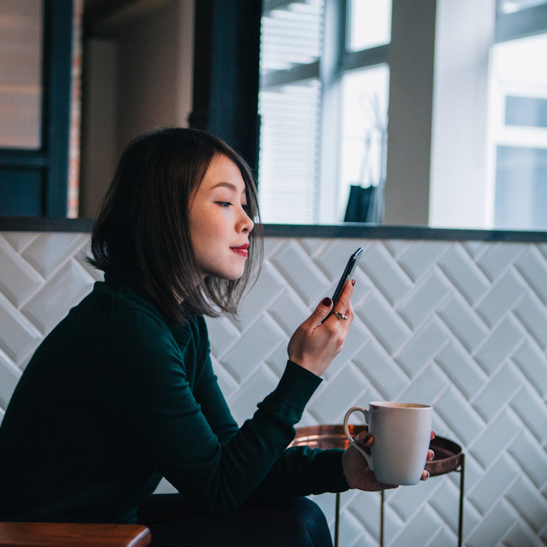 Customer on mobile phone in coffee shop